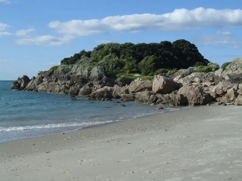 Rocky shoreline of Moturiki Island (Leisure Island) seen from Mt Maunganui beach