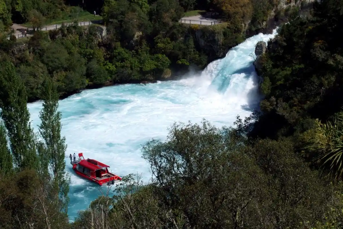 **Alt tag:** `Jet boat at the base of Huka Falls with the track visible above, Taupo`