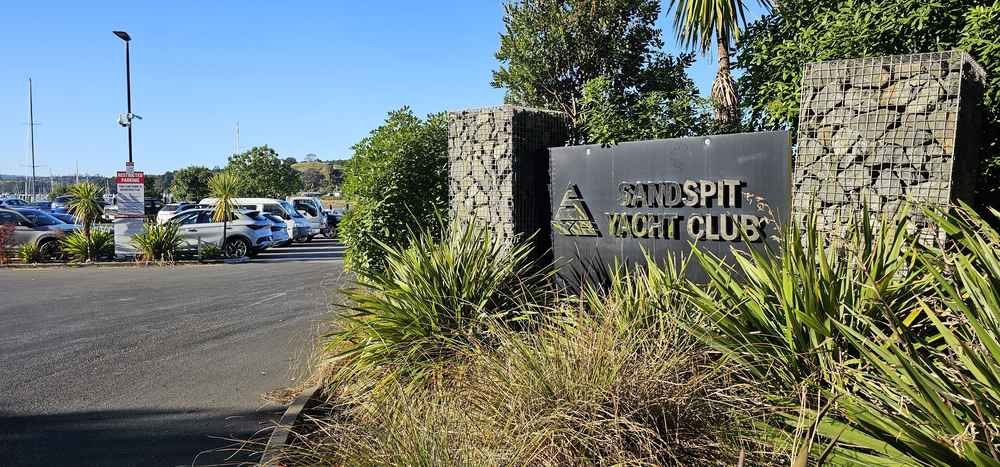 Sandspit Yacht Club entrance sign and car park