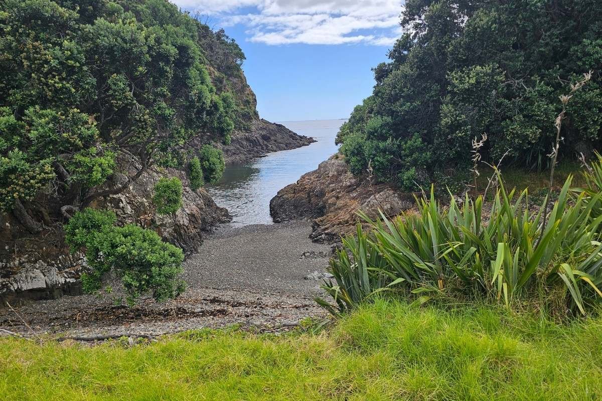Small secluded cove with pebble beach between rocky volcanic
headlands