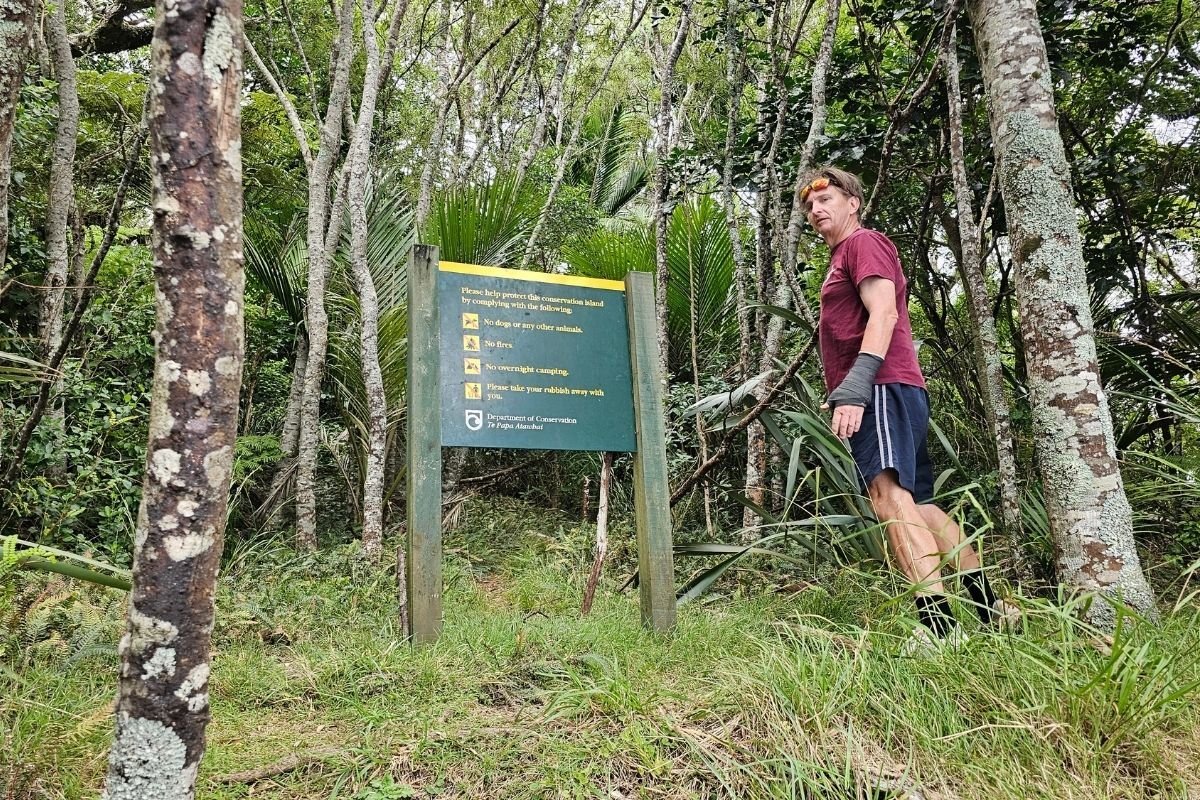 DOC conservation sign at Kiwiriki Track entrance Great Barrier Island